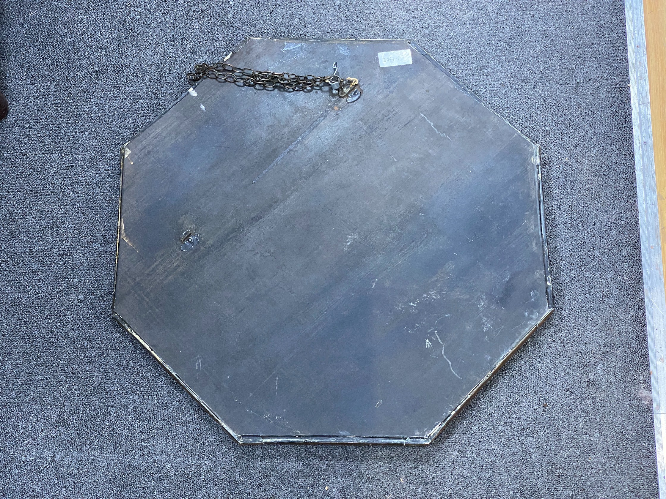 An Arts and Crafts octagonal copper framed wall mirror, width 63cm